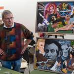 Jerry Smetzer stand next to his paintings that inspired his book Cassiopeias Quest at the Public Market in the Alaska State Museum building on Friday, Nov. 23, 2018. (Michael Penn | Juneau Empire)