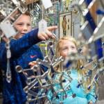 Tayt Whiteley, 8, and his sister, Delilah, 5, admire the stained glass snowflakes by Connie Nesgoda at the Public Market in Centennial Hall on Friday, Nov. 23, 2018. (Michael Penn | Juneau Empire)