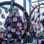 Timi Tullis looks at jewelry made of bicycle parts by Deb Winkelman at the Public Market in Centennial Hall on Friday, Nov. 23, 2018. (Michael Penn | Juneau Empire)