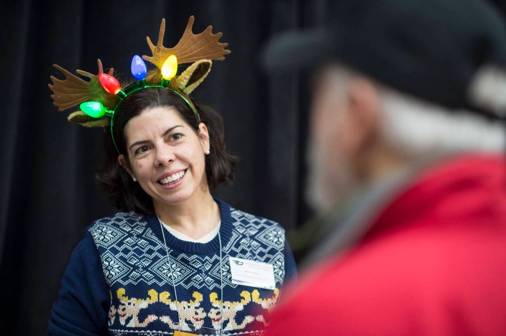 Julie York Coppens, Director of Outreach and Engagement for Perseverance Theatre, mans the theaters booth at the Public Market in the Elizabeth Peratrovich Hall on Friday, Nov. 23, 2018. (Michael Penn | Juneau Empire)