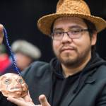 Samuel Sheakley Sr. shows of his copper piece titled Koo.eex Spirit at the Public Market in the Elizabeth Peratrovich Hall on Friday, Nov. 23, 2018. (Michael Penn | Juneau Empire)