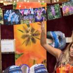 Mandy Ramsey of Soul Happy Art shows her photo prayer flags at the Public Market in Centennial Hall on Friday, Nov. 23, 2018. (Michael Penn | Juneau Empire)