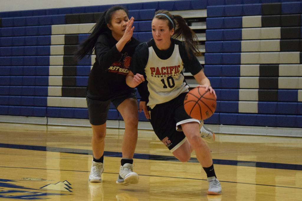 Juneau-Douglas alum Jualani Weimer, of Swoop Kids, drives around Juneau-Douglas senior Alyxn Bohulano during the first half on the Black Friday Tournament game at Thunder Mountain High School on Friday. Four womens and six mens teams participated in the double-elimination tournament run by the TMHS boys basketball program. (Nolin Ainsworth | Juneau Empire)