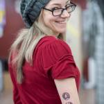 Amy Ridle displays her new stylized semicolon tattoo on her arm at Taku Tattoo on Monday, Nov. 19, 2018. (Michael Penn | Juneau Empire)