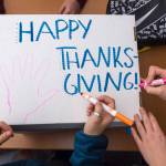 Juneau-Douglas High School student decorate a Thanksgiving dinner box full of food to be donated to AWARE and The Glory Hall on Tuesday, Nov. 20, 2018. (Michael Penn | Juneau Empire)