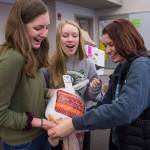 Juneau-Douglas High School freshmen Brooke Sanford, left, Margot Oliver, center, bag a turkey with senior Riley Stadt as they prepare Thanksgiving dinner boxes to be donated to AWARE and The Glory Hall on Tuesday, Nov. 20, 2018. The JDHS chapter of Sources of Strength, a nationwide organization that promotes positivity in schools donated seven boxes to the organizations. Students from every homeroom contributed food. (Michael Penn | Juneau Empire)