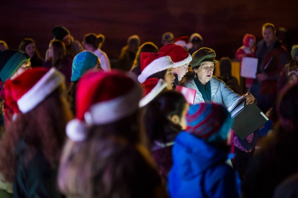 Members of The Voices of Alaska, directed by Missouri Smyth, sing Christmas carols at the annual Douglas Christmas Tree lighting at the Douglas Community United Methodist Church on Friday, Nov. 23, 2018. (Michael Penn | Juneau Empire)