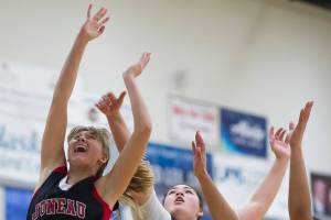 Juneau-Douglas Caitlin Pusich, left, shoots under the basket against Thunder Mountains Nina Fenumiai, center, and Kyra Jenkins-Hayes during their game at TMHS on Friday, Jan. 5, 2017. JDHS won 53-33. (Michael Penn | Juneau Empire File)