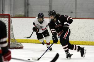 Juneau-Douglas Cameron Smith skates up the ice against Houston during the Big Lake Lions Christmas Classic Tournament last December in the Big Lake Lions Recreation Center. Houston plays JDHS this Friday and Saturday at Treadwell Arena. (Courtesy Photo | MatSuSports.net)
