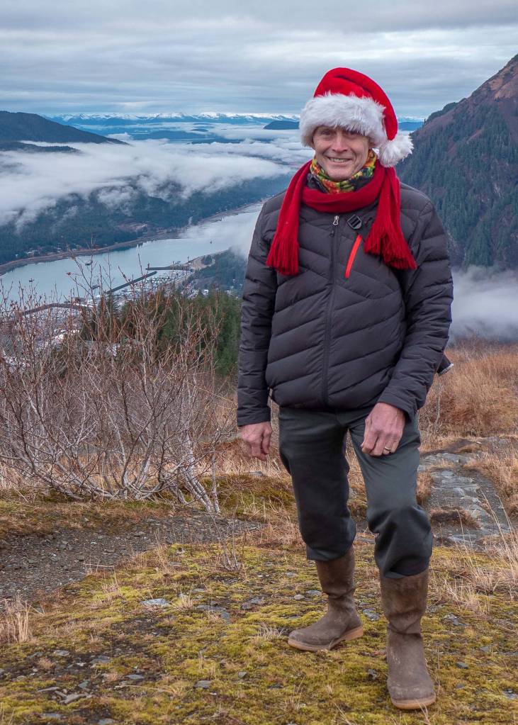 On this gray December day, it sure didnt look much like winter. But that didnt stop Mark Miller from getting into the holiday spirit on a hike with friends above the tram. Mandatory wardrobe for the mountain was his insulated jacket from Spyder, pants from Slates, and hiking boots from Le Chameau. His fleece neck gaiter, crimson chenille scarf and Santas hat brought color to the day and made everyone smile.