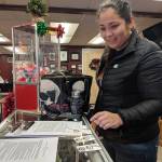 Davina Cole shows sketches of a tattoo she planned to get during a suicide prevention event at Taku Tattoo Friday, Nov. 30. Coles design included influence of the Northwest art form formline. (Ben Hohenstatt | Capital City Weekly)
