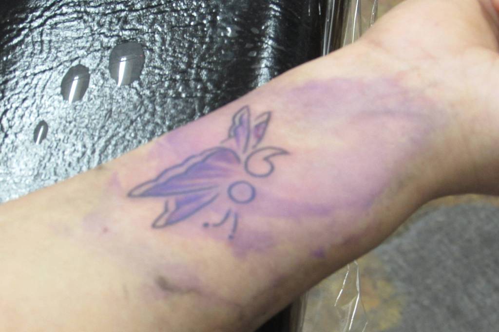 Theresa Hichman and her daughter, Erica Ranney who was visiting from Prince of Wales each got matching butterfly tattoos that incorporated semicolons. They were pleased with the work of Salty Jack Reed Jr., who did their matching tattoos. (Ben Hohenstatt | Capital City Weekly)