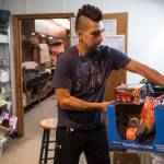 Marti Fred, facility coordinator for the Glory Hall, puts away donations of wool socks and hand warmers at the local soup kitchens and homeless shelter on Friday, Dec. 7, 2018. (Michael Penn | Juneau Empire)
