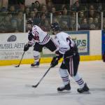 Juneau-Douglas Kyler Alderfer makes a pass up the ice while Tyler Weldon gets in position against Houston on Friday. JDHS won 7-0. (Nolin Ainsworth | Juneau Empire)
