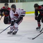 Juneau-Douglas Cameron Smith is chased by Houstons Blake Rogers, left, and Riley Scott in the first period at the Treadwell Arena on Saturday. (Nolin Ainsworth | Juneau Empire)