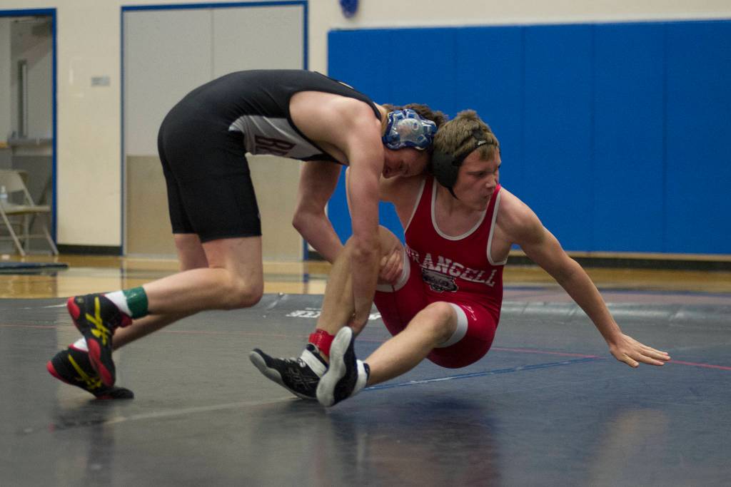 Juneau-Douglas senior Steven Ireland-Haight attempts to take down Wrangells Jake Eastaugh in the 171-pound consolation semifinals at the Brandon Pilot Invitational on Saturday, Oct. 21 at Thunder Mountain High School. (Nolin Ainsworth | Juneau Empire File)