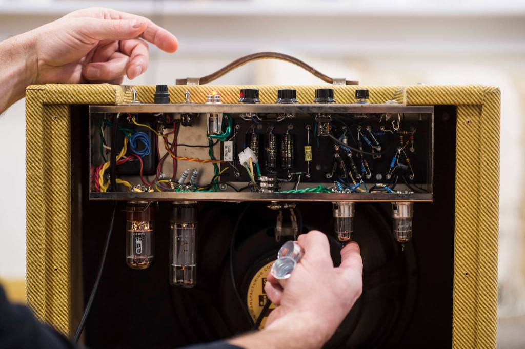 Reber Stein talks Wednesday, Dec. 5, 2018, about making tube amplifiers for his friends. Stein has been tinkering with the guitar amplifiers that make use of vacuum tubes for about a decade. Stein is responsible for the innards of the amplifier, but said his friend, Paul Gardinier made the cabinet that houses the tubes and wires. (Michael Penn | Juneau Empire)