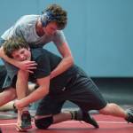 Senior Steven Ireland-Haight, top, workouts against sophomore Camden Erickson during Thunder Mountain High Schools wrestling team practice on Wednesday, Dec. 5, 2018. (Michael Penn | Juneau Empire)