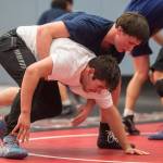 Sophomore Jake Ferster, top, workouts against senior Derek Mason during Thunder Mountain High Schools wrestling team practice on Wednesday, Dec. 5, 2018. (Michael Penn | Juneau Empire)
