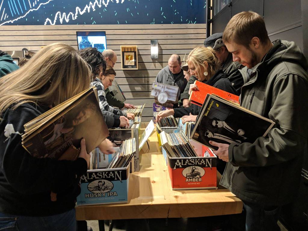 Alex Tadda, right, looks through records at the KXLLs pop-up record shop Thursday, Dec. 6, 2018. (Ben Hohenstatt | Capital City Weekly)