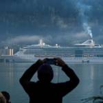A cruise ship passenger photographs the Radiance of the Seas in Juneaus downtown harbor on Tuesday, August 29, 2017. (Michael Penn | Juneau Empire File)