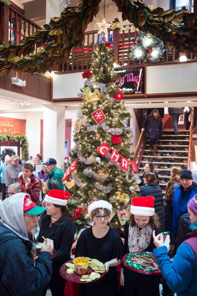 Students from the Floyd Dryden Middle School orchestra hand out cookies and other treats in the Senate Building during Gallery Walk on Friday, Dec. 7, 2018. The students were working to raise money for a trip to Disneyland. (Michael Penn | Juneau Empire)