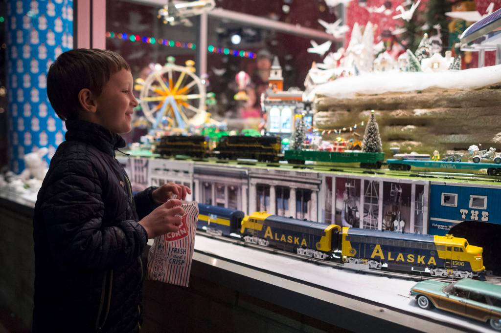 Zev LeVine, 7, takes in the holiday display at REACH during Gallery Walk on Friday, Dec. 7, 2018. It is the 15th year the display has been set up by Dan Elstad. (Michael Penn | Juneau Empire)