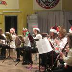 Taku Winds players donned Santa hats, reindeer antlers and elf caps for the closing number during the Homemade for the Holidays concert Saturday, Dec. 8, 2018. (Ben Hohenstatt | Capital City Weekly)