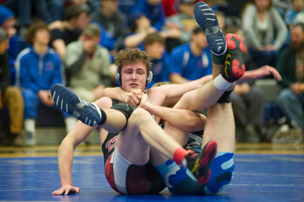 Juneau-Douglas Steven Ireland-Haight tries to free himself from Thunder Mountains Nick Nick Tiptons hold during their 171-pound finals match in the Region V Division I Wrestling Championships at TMHS on Saturday, Dec. 8, 2018. Tipton earned a 4-2 decision to win the region title. (Nolin Ainsworth | Juneau Empire)