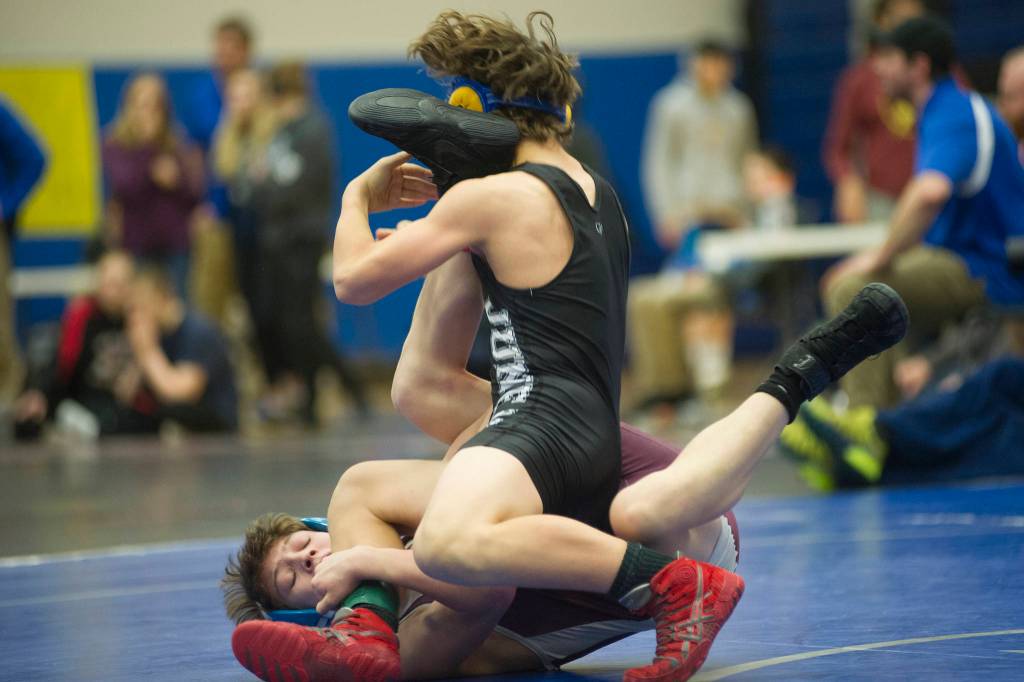 Thunder Mountains Kadin Messmer wrestles Ketchikans Degan Linne during their 103-pound finals match in the Region V Division I Wrestling Championships at TMHS on Saturday, Dec. 8, 2018. Linne pinned Messmer at 5:44 to win the region title. (Nolin Ainsworth | Juneau Empire)