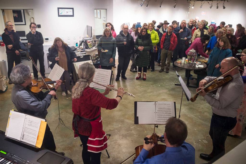 SaraNaTa, made up of Sara Radke Brown, Steve Tada, Nancy Nash, Andrew Schirmer, Jetta Whittaker, David Seid and John Staub perform Baroque tunes and carols at The Canvas during Gallery Walk on Friday, Dec. 7, 2018. (Michael Penn | Juneau Empire)