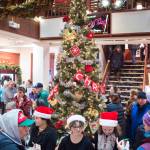 Students from the Floyd Dryden Middle School orchestra hand out cookies and other treats in the Senate Building during Gallery Walk on Friday, Dec. 7, 2018. The students were working to raise money for a trip to Disneyland. (Michael Penn | Juneau Empire)
