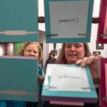 Cathy Needham, right, and Barb Sheinberg check out the The Rolodex Project//On Leadership by artist Sarah Campen, an interactive film and sculpture on display at The Davis Gallery in Centennial Hall during Gallery Walk on Friday, Dec. 7, 2018. (Michael Penn | Juneau Empire)
