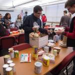 Juneau-Douglas High School senoirs Ramiro Garcia and Steven Ireland-Haight, right, fill a box with Thanksgiving dinner to be donated to AWARE and The Glory Hall on Tuesday, Nov. 20, 2018. The JDHS chapter of Sources of Strength, a nationwide organization that promotes positivity in schools donated seven boxes to the organizations. Students from every homeroom contributed food. (Michael Penn | Juneau Empire)