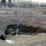 University of Alaska Fairbanks researcher Vladimir Romanovsky poses near Fairbanks in a place where permafrost has thawed, causing a surface disruption. (Courtesy Photo | University of Alaska Fairbanks)