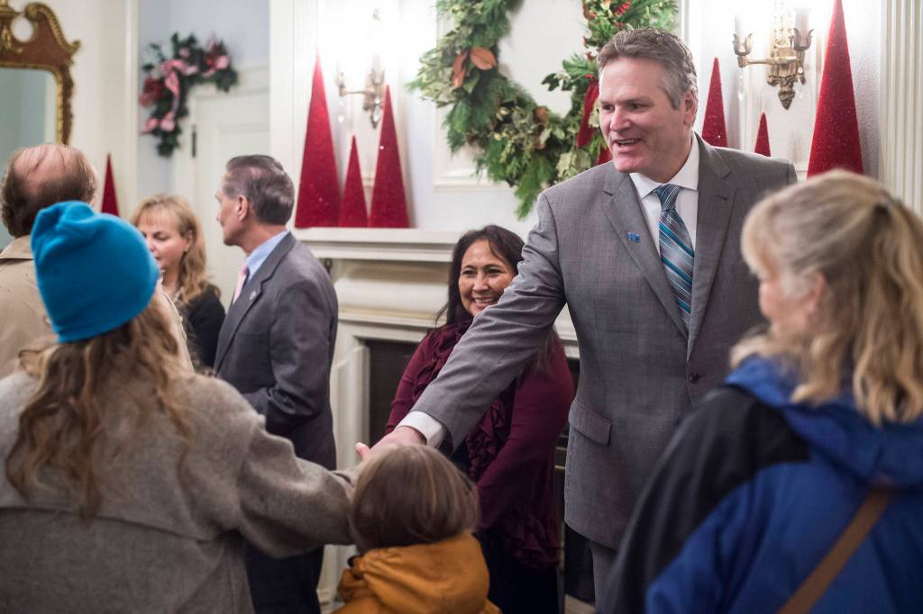 Gov. Mike Dunleavy and his wife, Rose, welcome Juneau residents at the Governors Open House on Tuesday, Dec. 11, 2018. (Michael Penn | Juneau Empire)