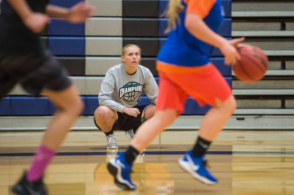 Coach Chandler Christensen watches over early morning girls basketball practice at Thunder Mountain High School on Tuesday, Dec. 11, 2018. (Michael Penn | Juneau Empire)