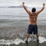 Marvin Pena steels himself for the annual Polar Bear Dip at Auke Recreation beach on Monday, Jan. 1, 2018. (Michael Penn | Juneau Empire File)