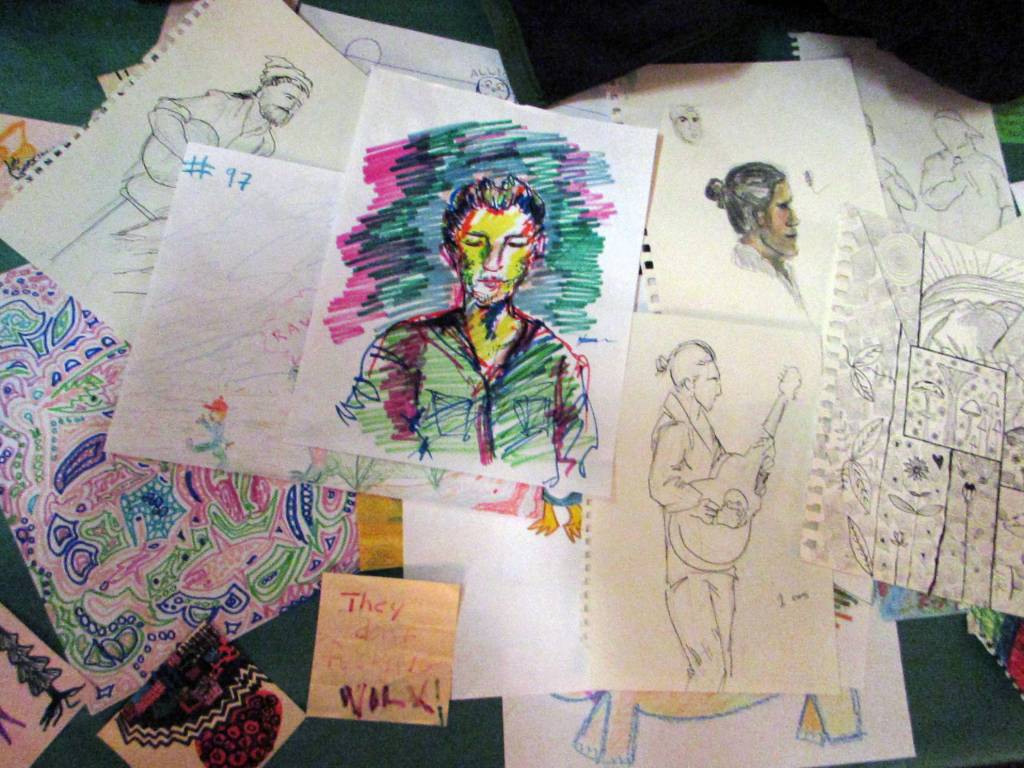 Artwork on display Thursday, Dec. 13, 2018 during the Mountainside Open Mic at the Rookery ranged from simple doodles to colorful portraits. All of it was drawn during the previous two months of open mic. (Ben Hohenstatt | Capital City Weekly)
