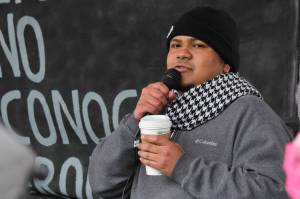 Manni Guillen, whose family moved to Juneau from Mexico when he was a baby, speaks at the Love Knows No Borders rally in Juneau on Saturday, Dec. 15, 2018. Guillen spoke about his experiences growing up in Juneau and working with the Border Angels nonprofit. (Alex McCarthy | Juneau Empire)