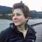 Artist Julienne Pacheco, who makes jewelry out of fish skin and other natural materials, poses on the downtown Juneau Seawalk with earrings made out of arctic grayling dorsal fins. (Courtesy Photo | Julienne Pacheco)
