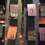 Earrings created using the skin of salmon and other wild Alaska fish, created by Juneau artist Julienne Pacheco, are on display at Juneaus Public Market in November of 2017. (Mary Catharine Martin | SalmonState)