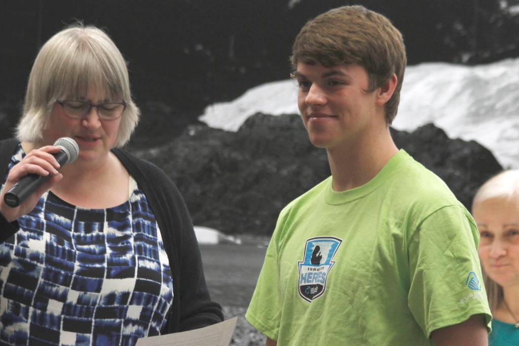 Bergen Davis, right, smiles as Mayor Beth Weldon congratulates him on being named a Hero of the Summer by Alaska Communications. Davis has donated time and money to Juneaus homeless population since he was a child. (Alex McCarthy | Juneau Empire)