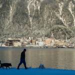 Mike Donnellan takes a short walk in the fresh snow near the Mike Pusich Douglas Harbor with his dog, Denali, on Thursday, Dec. 20, 2018. (Michael Penn | Juneau Empire)