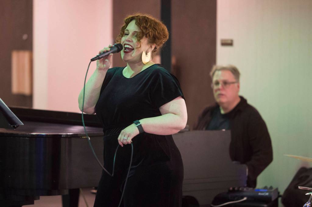 Juneau Cabaret singer Margeaux Ljungberg sings for Juneau residents as she is accompanied by Tom Locher during the third annual Holiday Extravaganza at Centennial Hall on Wednesday, Dec. 19, 2018. (Michael Penn | Juneau Empire)