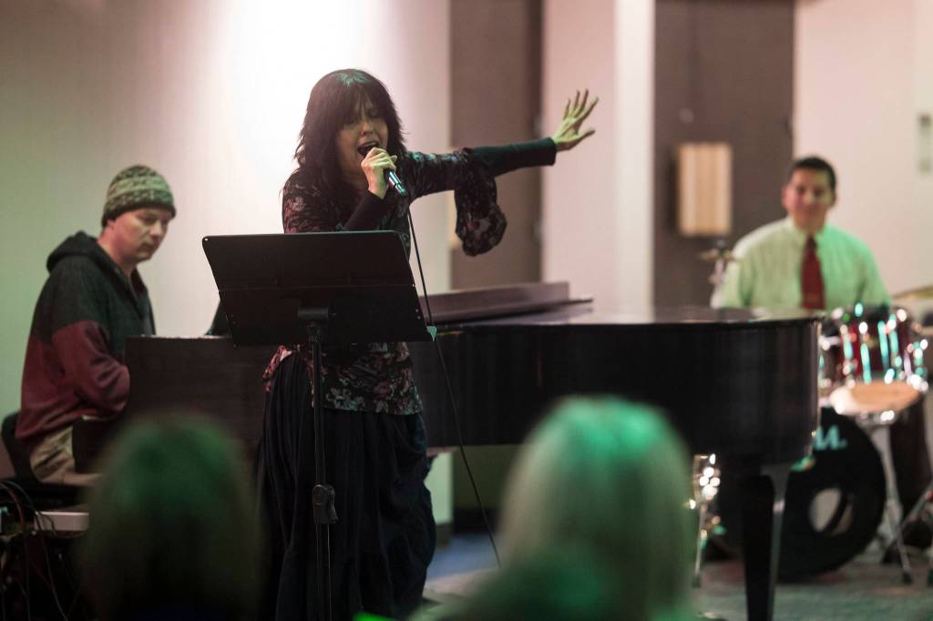Juneau Cabaret singer Lynda Stover sings for Juneau residents as she is accompanied by Luke Weld and David Sheakley-Early during the third annual Holiday Extravaganza at Centennial Hall on Wednesday, Dec. 19, 2018. (Michael Penn | Juneau Empire)