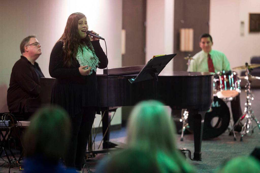 Juneau Cabaret singer Alyssa Fischer sings for Juneau residents as she is accompanied by Tom Locher and David Sheakley-Early during the third annual Holiday Extravaganza at Centennial Hall on Wednesday, Dec. 19, 2018. (Michael Penn | Juneau Empire)