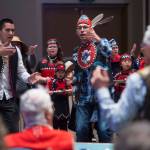 Tlingit Culture Language and Literacy Dance Group instructors Joshua Jackson, left, and Hans Chester from Harborview Elementary School dance with their students during the Voices of Our Ancestors Language Summit at Centennial Hall on Tuesday, Nov. 13, 2018. (Michael Penn | Juneau Empire)