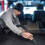 Lead Detailer Calvin Olsen works at vacuuming a vehicle at a new auto detailing business called Sacred Shine offered by the Central Council of the Tlingit and Haida Indian Tribes of Alaska on Friday, Dec. 21, 2018. (Michael Penn | Juneau Empire)