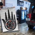 Lead Detailer Calvin Olsen shows the logo developed for a new auto detailing business called Sacred Shine offered by the Central Council of the Tlingit and Haida Indian Tribes of Alaska on Friday, Dec. 21, 2018. The logo was designed by tribal member Miciana Hutcherson. (Michael Penn | Juneau Empire)